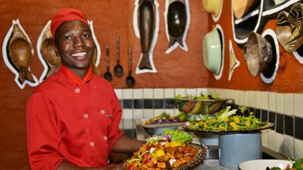 Image 1 - Boma - Dinner & Drum Show chef Tendai Mutava at the salad bar with the new decor in the background.j
