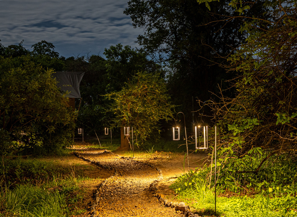 MAWIMBI Bush Camp - pathway leading to one of four exclusive Tented Suites at night