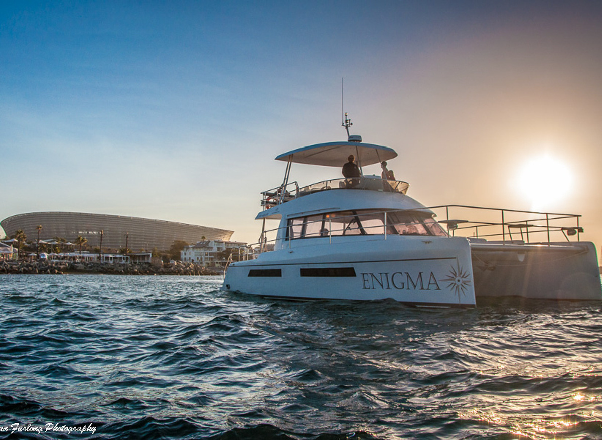 Enigma Catamaran at Sunset with Cape Town Stadium Backdrop