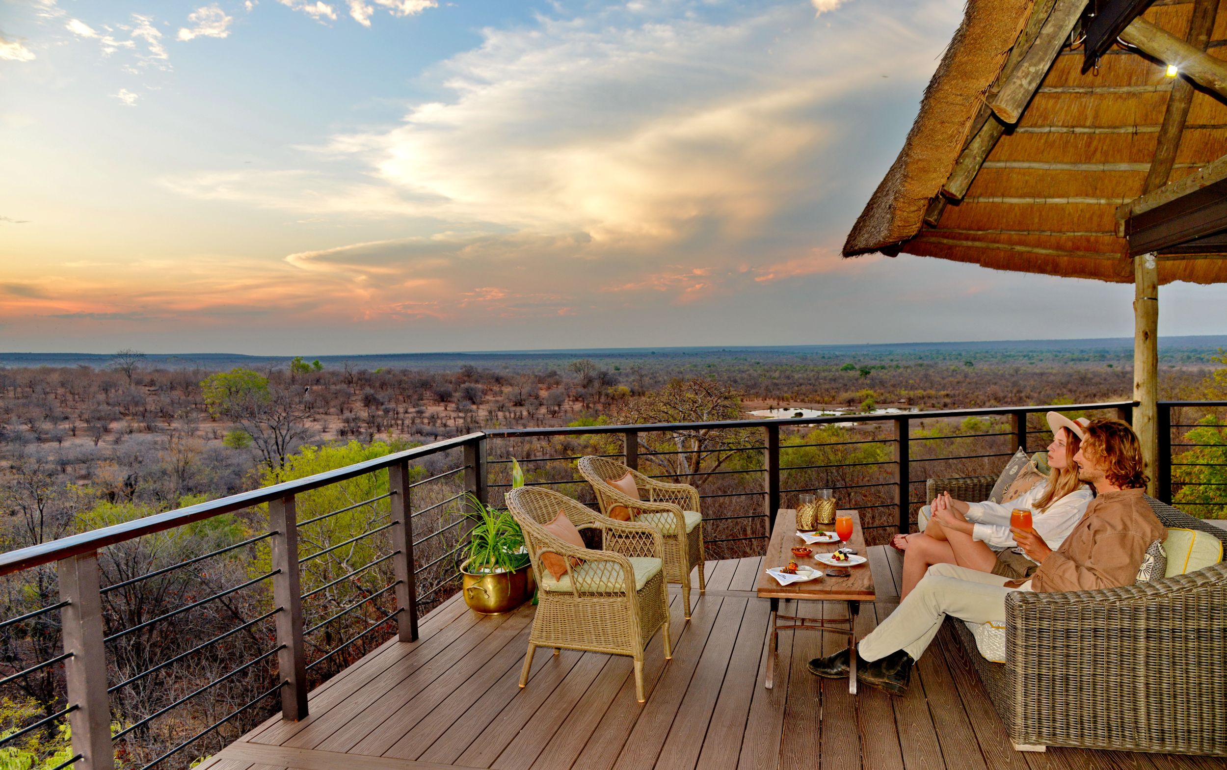 A couple enjoying the sunset from Victoria Falls Safari Club's viewing deck.JPG