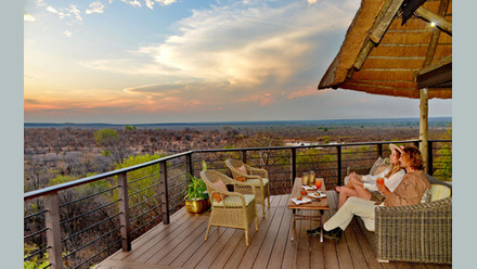 A couple enjoying the sunset from Victoria Falls Safari Club's viewing deck.JPG