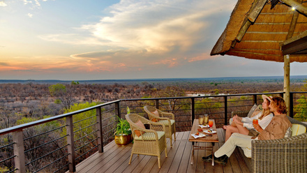 A couple enjoying the sunset from Victoria Falls Safari Club's viewing deck.JPG