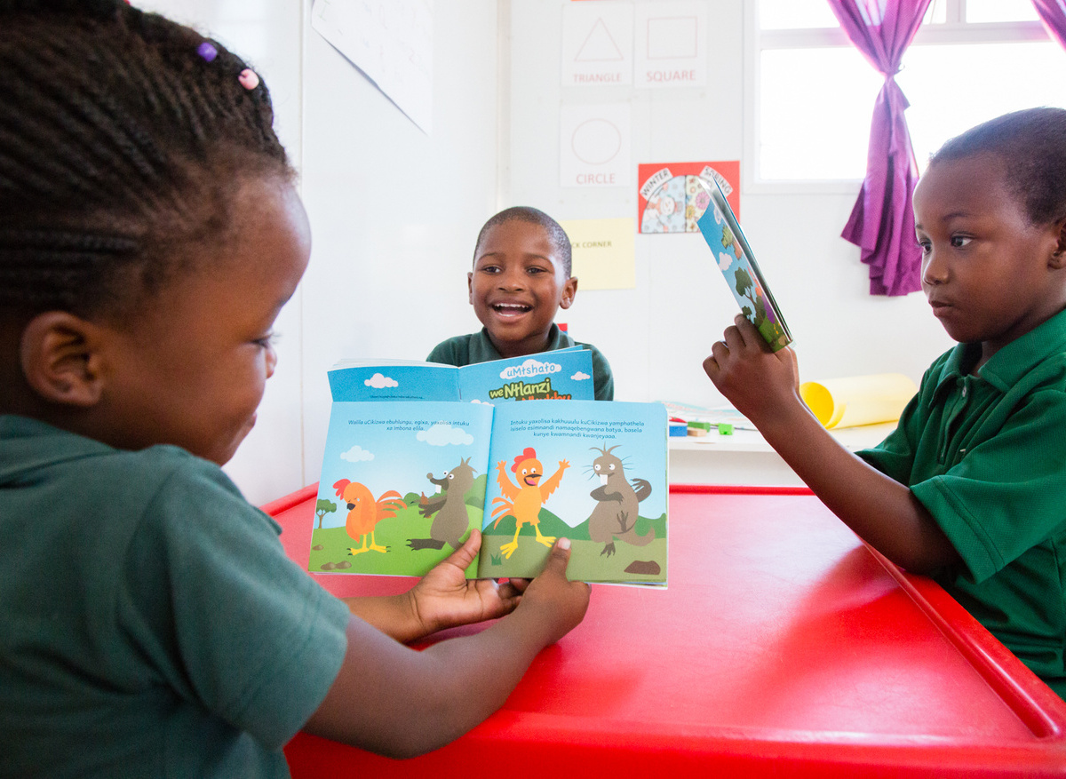 Children reading age-appropriate storybooks