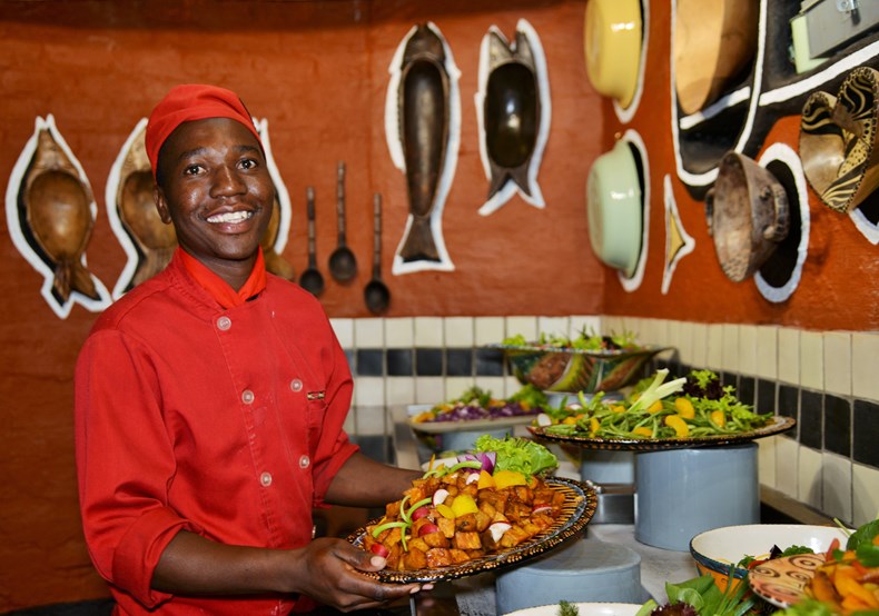 Image 1 - Boma - Dinner & Drum Show chef Tendai Mutava at the salad bar with the new decor in the background.jpg