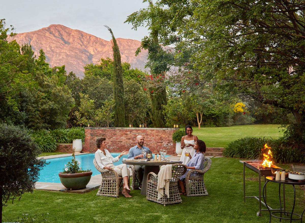 LA-CLE-DES-MONTAGNES---La-Clé-Village---Manoir---Outside-braai-with-guests-around-the-table.jpg